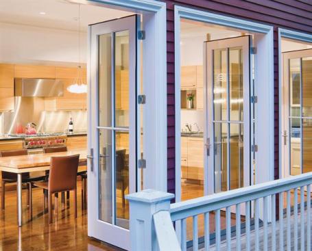Three pairs of French doors open the kitchen to the houses side deck.