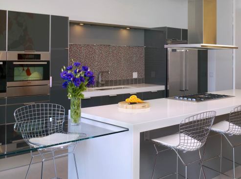 The kitchen island also transforms with a glass dinging table that slides in and out.