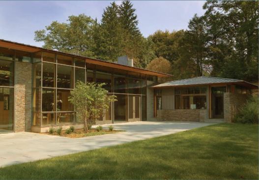 Sited near an interstate highway, this family house forms a number of quiet, sheltered courtyards.