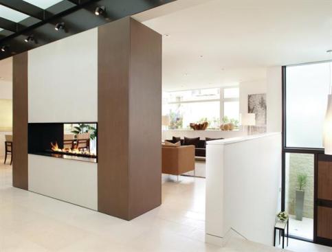 A two-story entry hall lends a sense of verticality to the living and dining areas at the front of the house.
