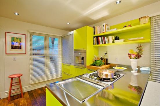 Stainless steel counters, integrated appliances, and roll-up and sliding-door storage minimize unnecessary obstruction.