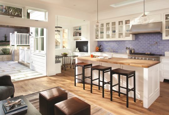 In the kitchen, custom VOC-free plywood cabinets with FSC-certified doors are paired with Caesarstone countertops, Fireclay Tile's Debris Series tile, and engineered 8-inch White Oak FSC-certified plank flooring.