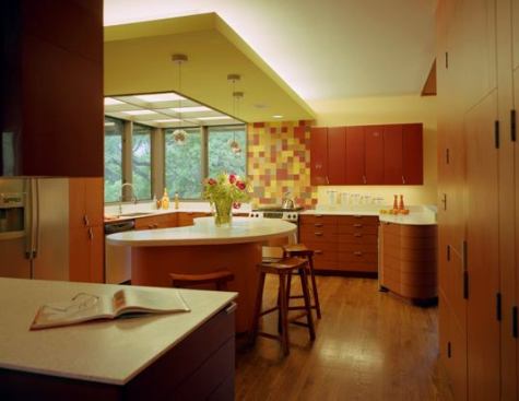 Large windows open the space and allow a view of the yard's oak trees and, in the distance, a glimpes of downtown Austin. The corner soffit combines flexible lighting into a single element that defines the work area. A luminous ceiling is integrally mulled to the corner windows.