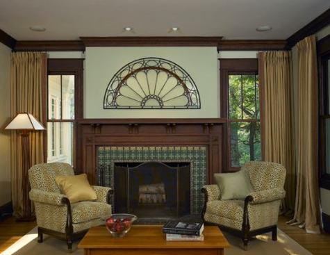 The addition of a satin mat-finished stained oak fireplace surround and distinctive tile -- with an Arts and Crafts stem-and-flower motif -- connect the original fireplace seamlessly to the home's predominant style.