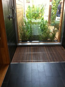 A large window in the bathroom offers a view to the outdoors, while an on-site wetland helps filter and recycle greywater from the shower, clothes washer, and dishwasher.