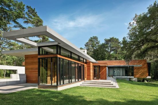 Glass walls line the rear of the house, the better to enjoy distant water views.