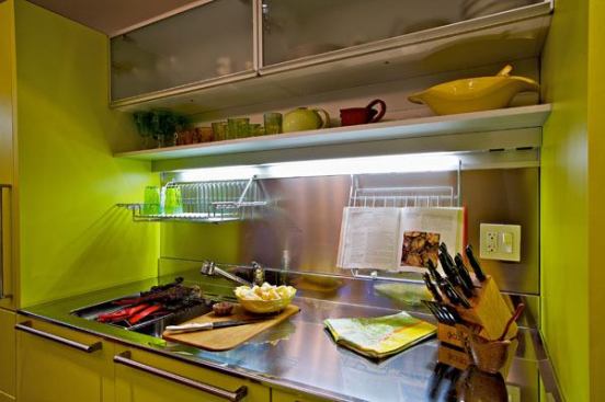 Two tall homeowner-chefs and ceiling heights of only 7'10" necessitated efficient space design. Upper wall units have acid-etched glass doors.