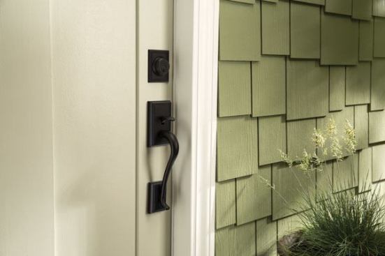 A matte black handleset for the front door adds a sense of drama to a home's entrance.