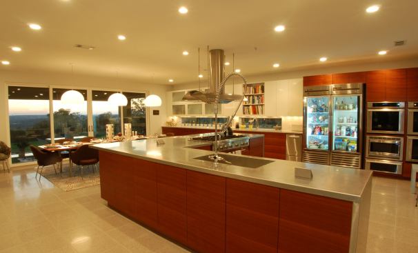 Built for a chef in Austin, Texas, this home kitchen has the tough-and-ready good looks of a commercial version thanks to some ultra-durable appointments, such as a large-winged faucet with an extendable nozzle, stainless steel countertops, a super-sized vent hood, and a restaurant-style refrigerator. Project: Knollwood Kitchen, Austin; Builder: BDH Construction, Inc., Austin; Architect: Cornerstone Group, Austin