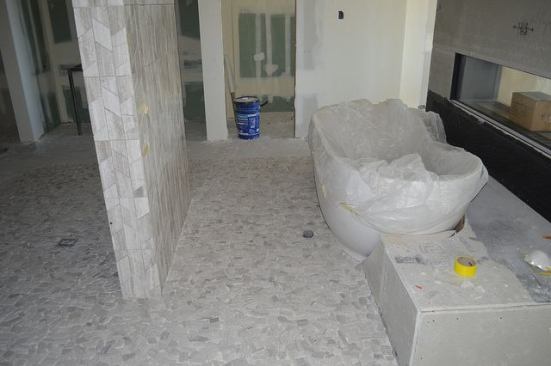 Pale-colored tile flooring provides a nature-inspired element in this bathroom.
