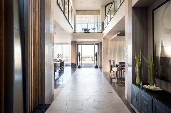 The first floor is arranged around a tile floor "runway" that extends from the entry court through the core of the house.