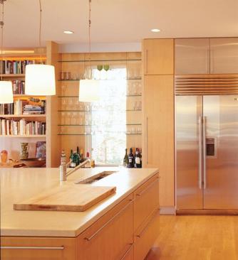 The zone-driven layout invites interaction between the kitchen and living space.