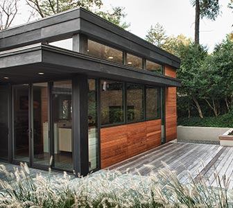 To make room for a new kitchen and entertainment space, this home’s existing kitchen and dining room were combined and given a new addition in a design that makes use of 11-foot ceilings with clerestory windows atop large picture windows that invite the landscape in. Project: Utah Street Residence, Arlington, Va.; Architect: Jon Hensley Architects, Arlington