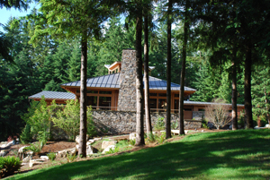 The building's two wings are defined by their contrasting roof forms: a centrally focused hip roof over the great room