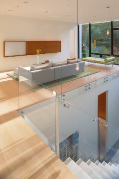 A glass railing minimizes the separation between first- and second-floor spaces.