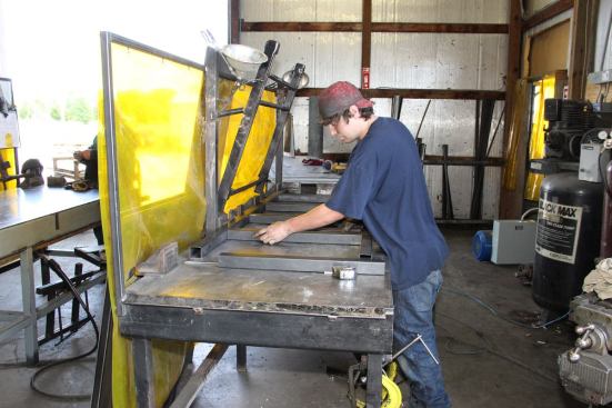 A worker assembles the steel frame of a Twister Safe tornado shelter in the Twister Safe manufacturing facility a few miles south of Joplin, Missouri. The company has expanded operations following the units’ successful performance during the tornado.