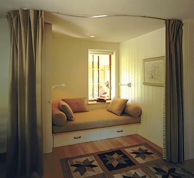 The building shell's many offsets and overhangs translate here into nooks for intimate seating and sleeping places.