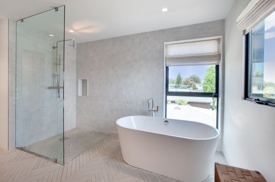 The staircase provides views to the indoor/outdoor space below and lets in natural light.