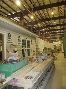 A worker at the Rocky Mount plant nails siding onto a module that will become an office building. Supplying commercial projects has become a growth opportunity for IBS.