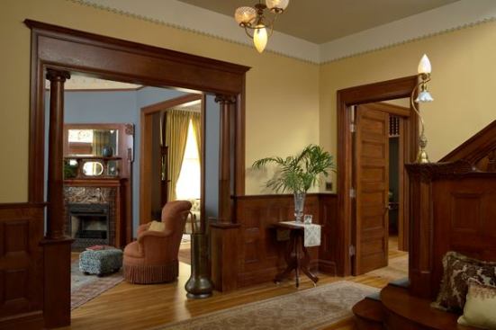 Non-original French doors were removed from the opening between the foyer and parlor, and the opening was restored. Other restored elements included tile fireplace surrounds, windows, flooring, and decorative stencil.