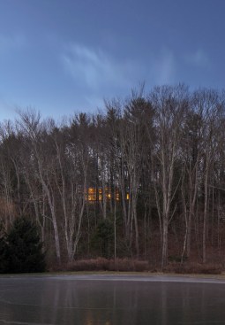 The house can be glimpsed glowing through the trees during the approach, becoming a beacon for passing cars. 