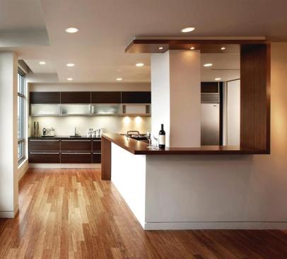 A bamboo counter winds from floor to ceiling, creating a distinctive boundary between the kitchen and the adjacent dining area.