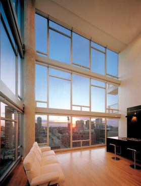 Inside, rough exposed concrete pillars complement refined hardwood floors.