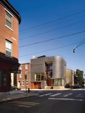 The bullnose facade references other corner buildings on the street.