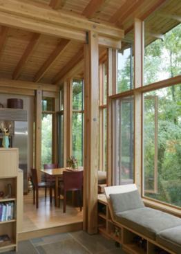 Built-up columns carry roof loads inside the building, permitting a thin roof structure and freeing the perimeter of the building for a light, wood-framed curtain wall system.