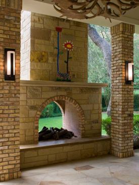 In this backyard, a two-sided fireplace does double duty as fire pit and patio wall. Architect: Jay Corder; Builder: David Wilkes, David Wilkes Builders; Fireplace Design:  David Wilkes, David Wilkes Builders