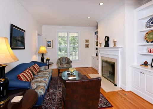The traditional detailing continues inside with white-painted built-ins and crown moldings.