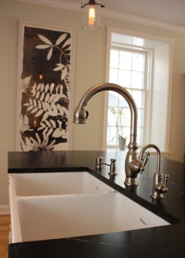This farmhouse had received several updates and renova-
tions over the years. However, the floor plan was conflict-
ing amongst the kitchen, laundry, mudroom, and powder 
room. A complete reorganization of the first floor was 
achieved through multiple structural changes that al-
lowed for a larger kitchen and created better flow be-
tween adjacent rooms. The kitchen includes custom 
painted cabinetry, a farmhouse style sink, and soapstone 
countertops. A commercial size Viking range, hood, and 
Sub Zero refrigerator bring a theme of stainless steel to 
the kitchen which is accentuated by brushed nickel hard-
ware and island faucet. Specialty lighting, glass door 
cabinets, and a grand, eight foot island are just a few of 
the features that make this kitchen stunning.