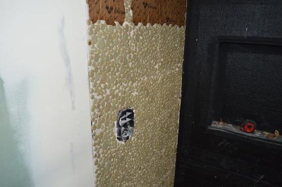 The pebbles continue up the wall.