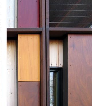 Alternating layers of glass, unfinished cedar, and glossy Prodema give the fa??ade a dynamic quality.