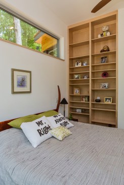 A recessed, custom bookcase leaves floor space unencumbered.