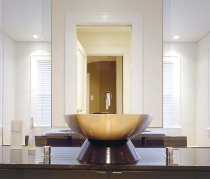 A slightly dropped ceiling panel visually defines and separates the bathing area.