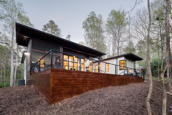View from  nearby creek to back pool area, deck, and terrace