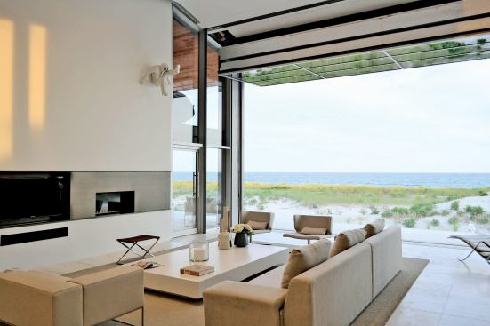 The 26-foot-wide fold-up aluminum and glass door allows the homeowners a clear view of the dunes and waters beyond.
