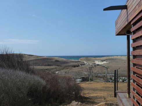 The home’s 1,199-square-foot floor plan occupies an existing foundation, which is the only reason the house could be built. “We went in with the attitude of being really respectful to that site,” says Hutker. “It’s designed to look like a little weathered box sitting in the landscape.”