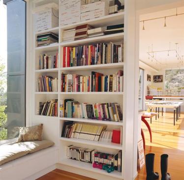 A little library forms one end of the workspace. 