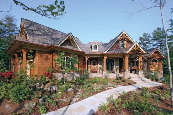 9. Home in the Woods: Wrapping porches and generous windows provide ample opportunities for calming views in this 3,126-square-foot rancher with craftsman detailing. Inside, find modern warmth in the large lodge room complete with fireplace and window wall. Multiple vaulted ceilings, a deluxe master suite, and an optional apartment over the garage add real luxury. For more images and information, click 
here. 