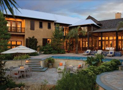 The site's most notable constraint—a deeply sloping lot with a 12-foot grade change—became an asset in the quest for private outdoor living space. In back, the home wraps around a terraced courtyard, pool, and gardens, with expansive windows, balconies, and loggias oriented toward the view. Moroccan flavors get their due in this secluded backyard retreat, as well as in interior spaces.