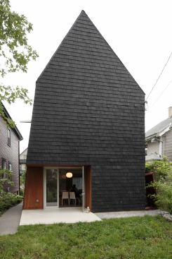 The almost solid rear elevation blocks undesirable views of nearby houses. The patio is cut out from the building's form to provide protection. "The cutouts also de-emphasize the volume," Sokol says. That volume is clad in EcoStar shingles that are manufactured using recycled tires Sokol adds.