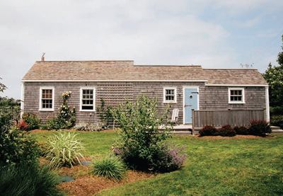 Vacation homes often grow larger when renovated, but this updated Massachusetts cottage maintained the scale of its neighbors. Restraint was in keeping with the client's wishes, but as a side benefit, it ensured compliance with architectural restrictions set by the local Historic District Commission.