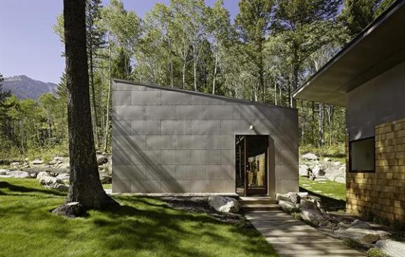 The buildings shed roofs suit the areas snowy winters. Boulders found on the site form an organic landscape element.