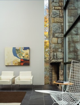 The fireplace occupies the corner of the lower-level living room, freeing up the rest of that rear wall for views