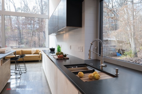 The window over the sink frames a view of the old barn on the property.