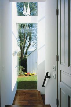 Heart-pine floors serve the same purpose in the stairs and hallway leading to the addition.