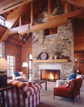 Twin opposing shed dormers lighten the voluminous roof of the great room. The chimney "window" gives the second-floor loft a view of the public space below.