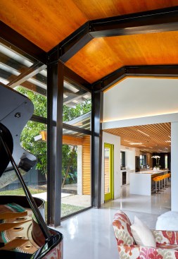 Steel girders and custom steel framework with expanses of glass encase the jewel-box family room, formerly the garage. 